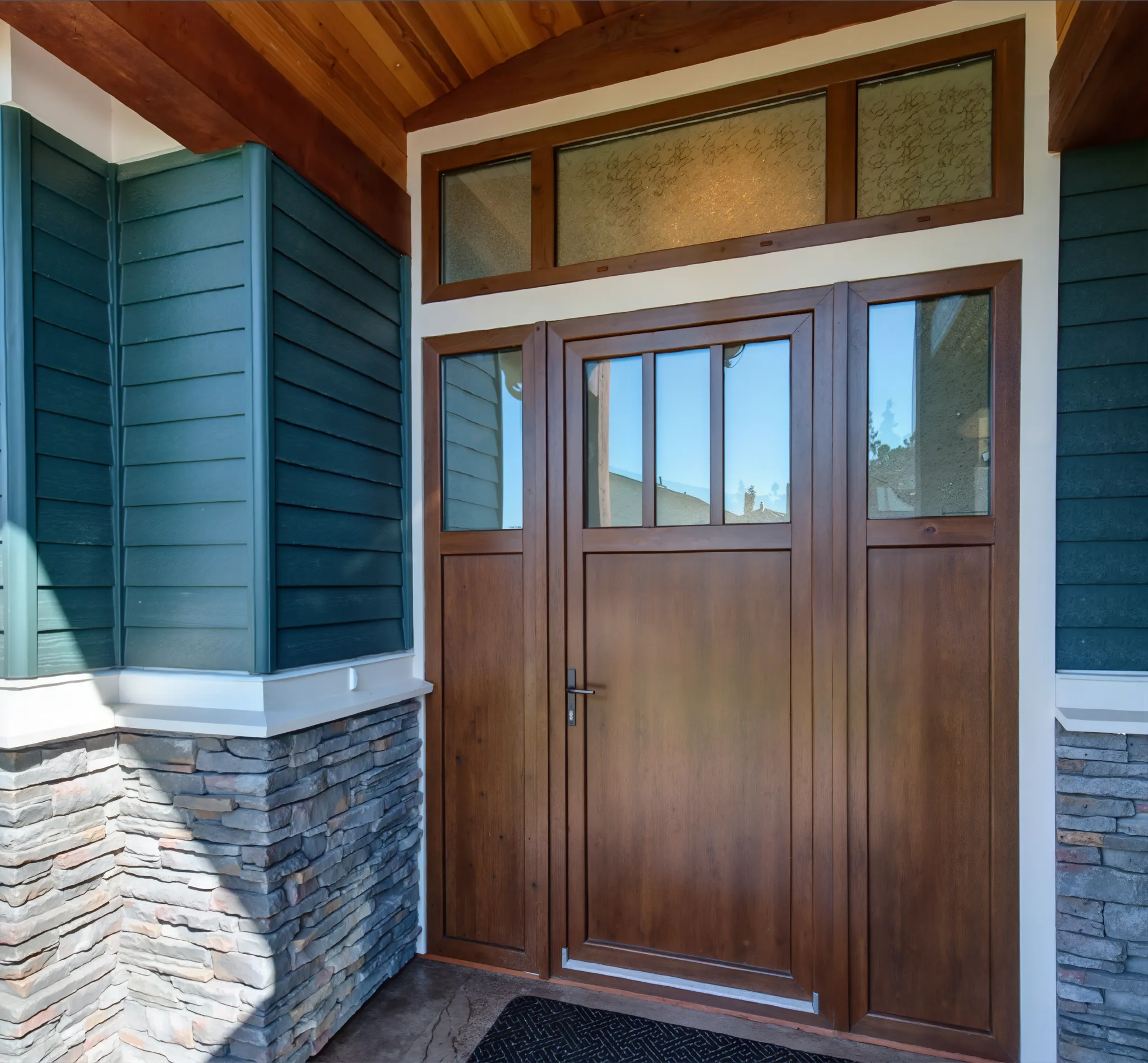 Traditional wood-look entry door with divided glass and sidelights