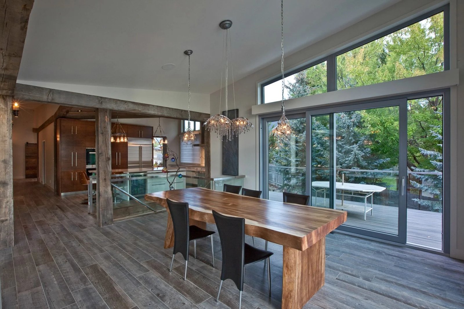 Dining area opening to a deck through a wide lift and slide door