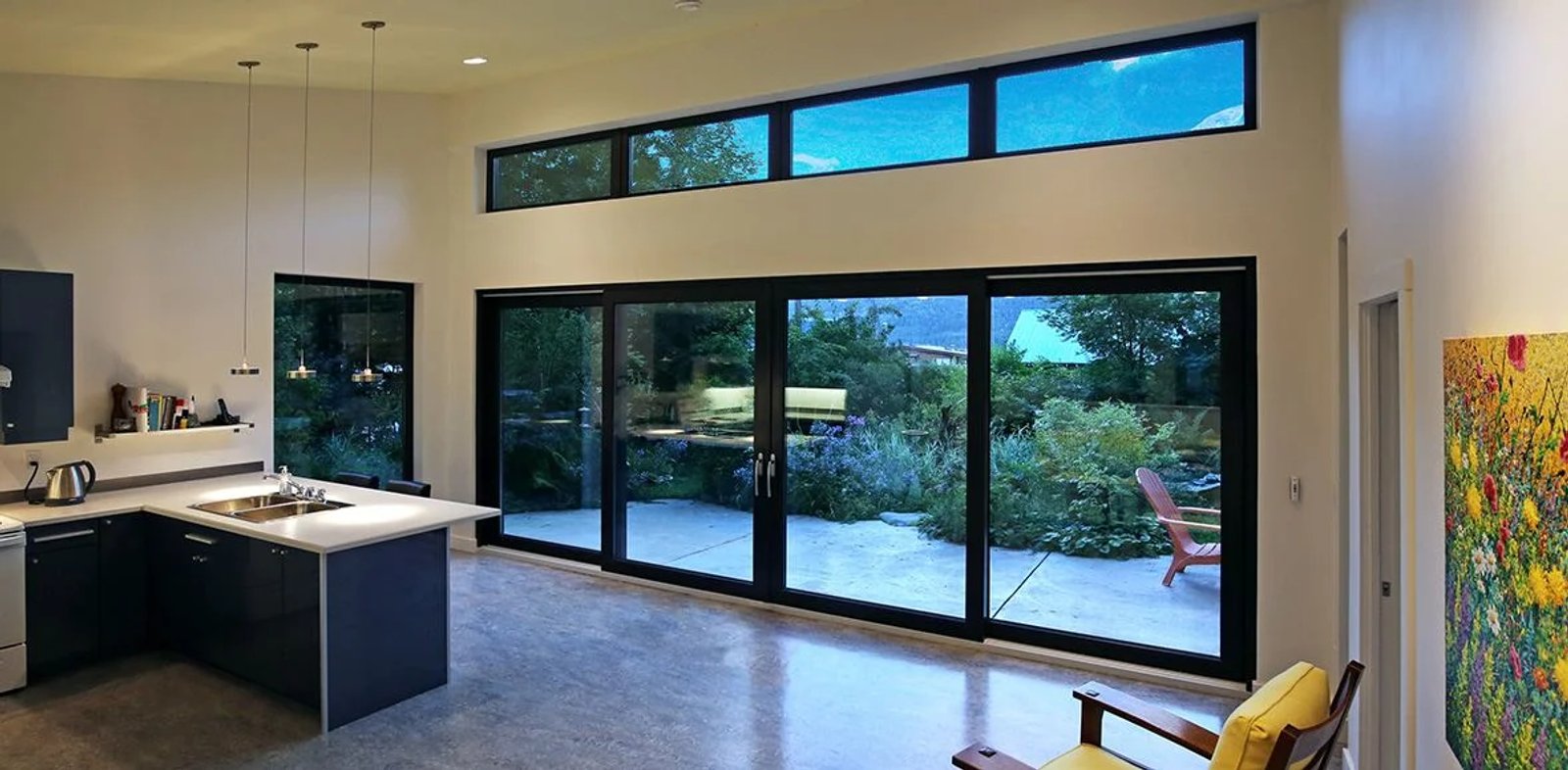 Kitchen with a wide four-panel sliding glass wall and transoms