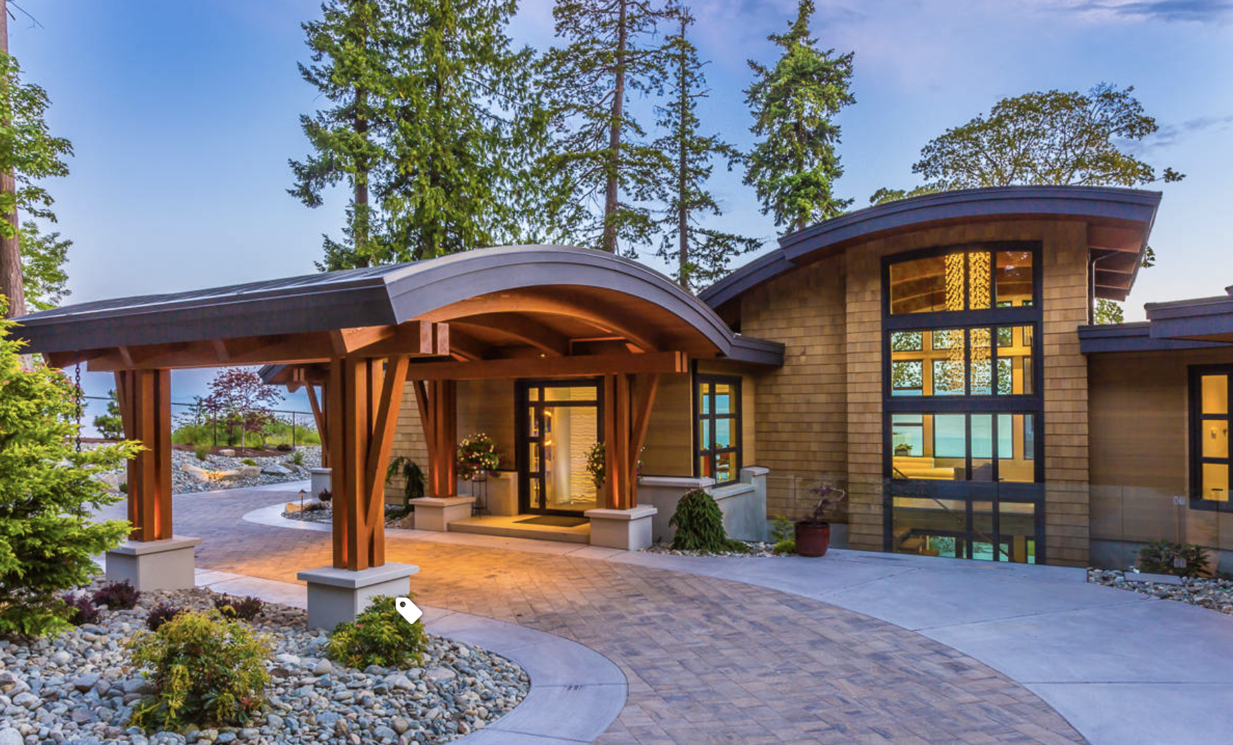 Modern home with curved rooflines and warm timber accents featuring Innotech windows